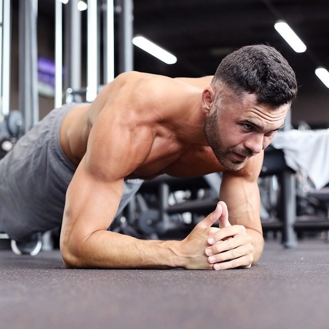 exercise-plank-senior-man-with-coach-recovery-support-physical-therapy-retirement-physio-people-lesson-with-training-floor-mobility-rehabilitation-joint-strength 1